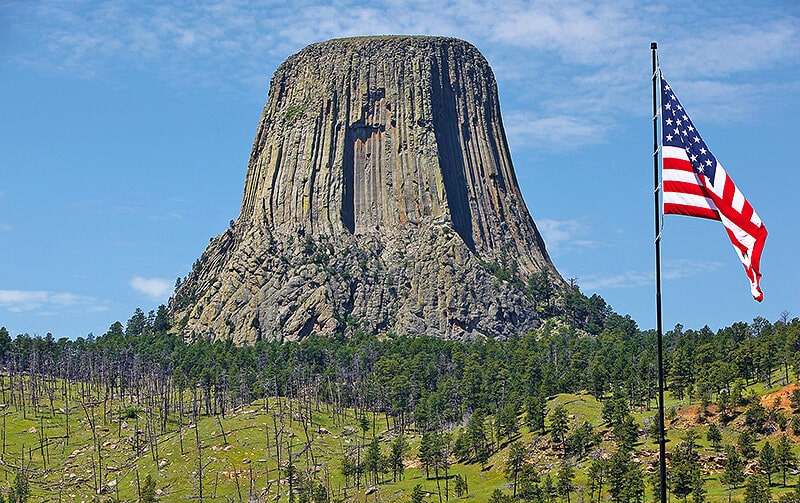 La Torre del Diavolo (Wyoming) accanto a una bandiera americana