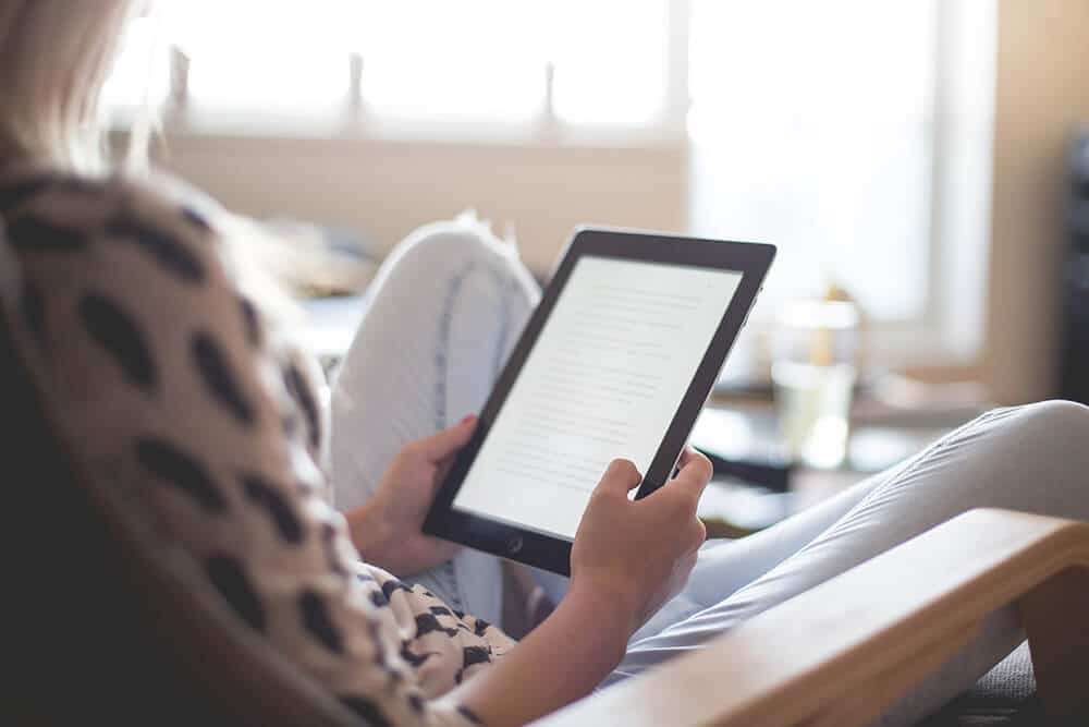 Woman reading a book on a tablet