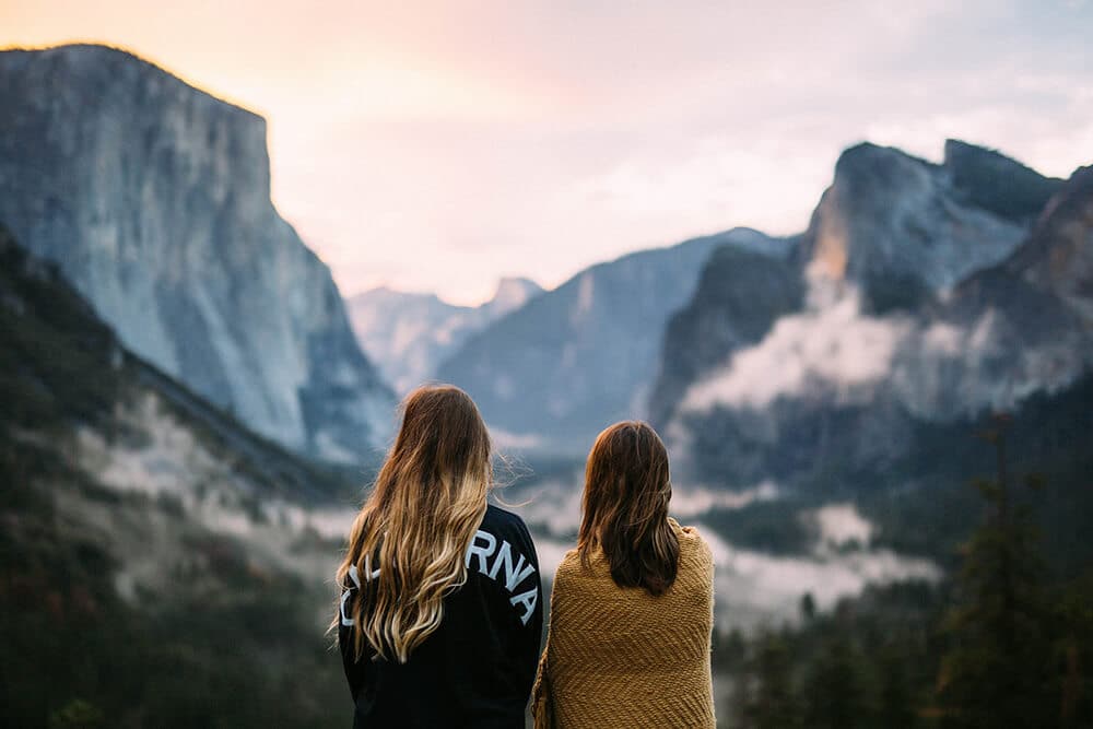 Girls enjoying a beautiful sunset at Banff wrapped up in woolen scarves