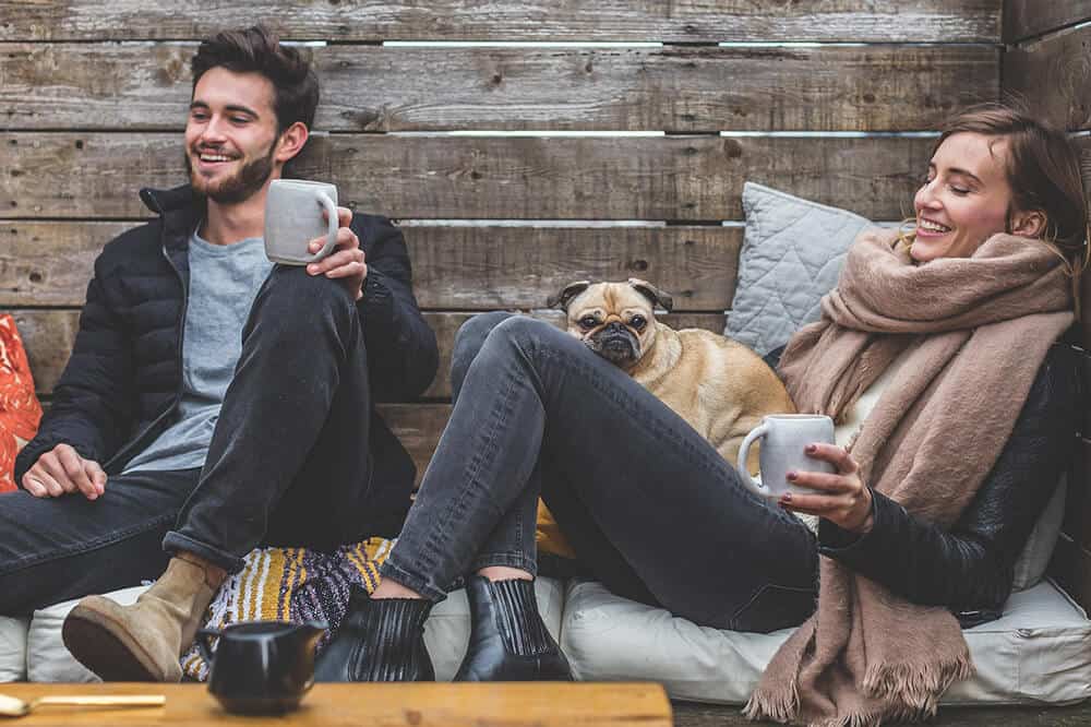 Couple having fun and sipping hot cocoa on a Europe winter trip