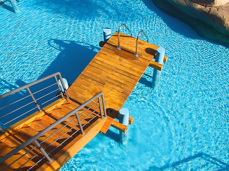 Luxury swimming pool with a wooden walkway