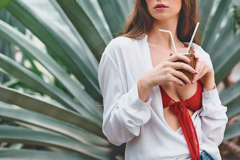 Girl sipping a coconut cocktail in Miami