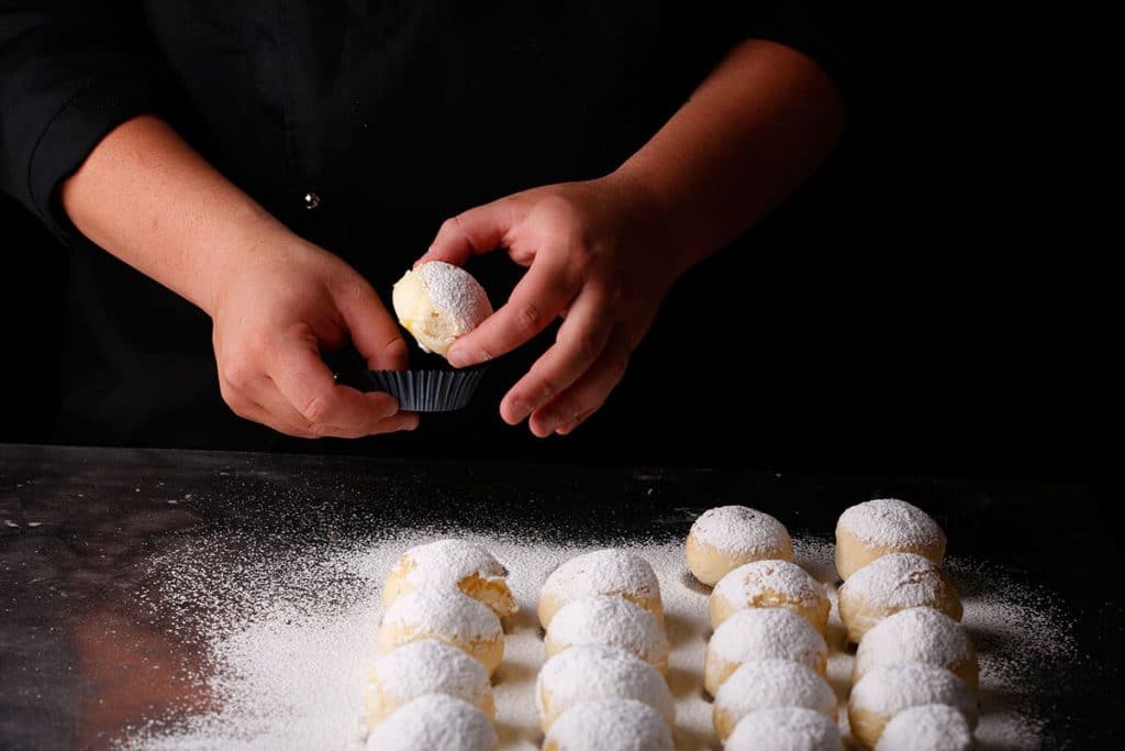 Confictioner making fiocco di neve pastries