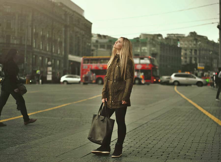 Girl looking up in a grey morning with Milan in the background