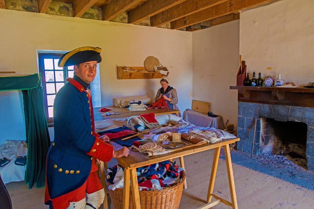 Visit Fort Ticonderoga - our guide and a seamstress working on a few uniforms