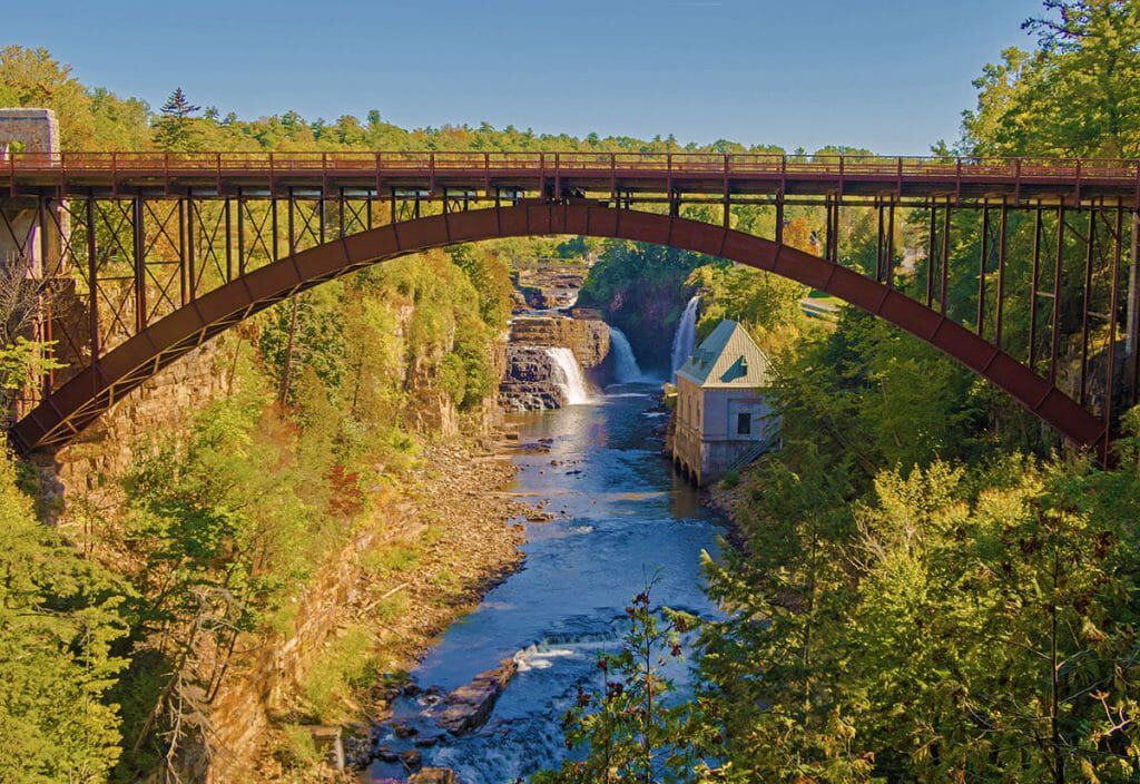 View of the waterfalls at Ausable Chasm through the iron bridge