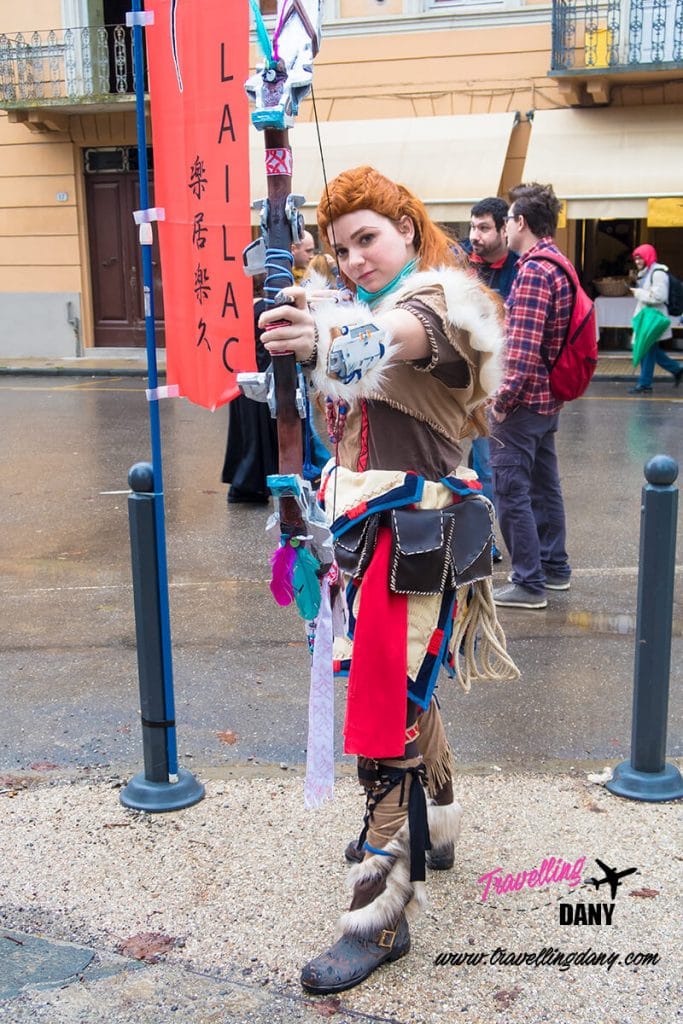 Cosplayer in Lucca wearing an anime costume with a long bow