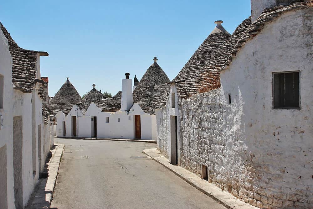 View of a narrow street between trulli in Puglia, Italy