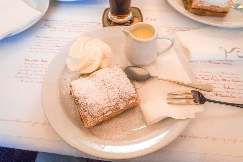 Apple strudel with whipped cream and a brik of caramel at Cafe Louvre in Prague