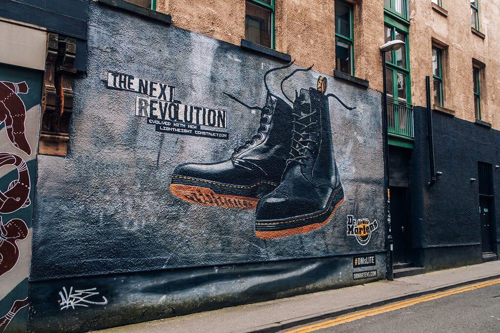Northern Quarter Urban Art - A pair of Doc Martens boots with the text "The next revolution"