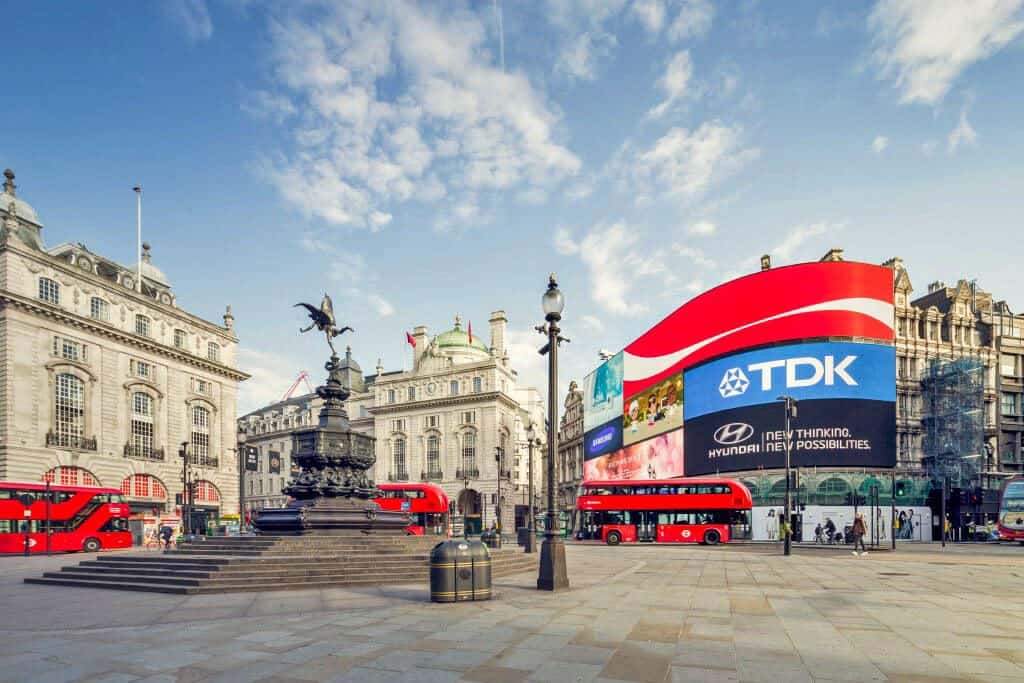 Piccadilly Circus in London with red buses and the huge Daktronic display