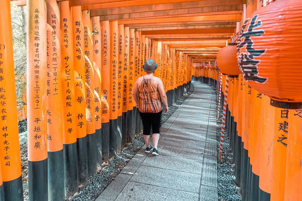 Fushimi Inari Shrine - Dany walking under the thousands vermilion tori at Fushimi Inari