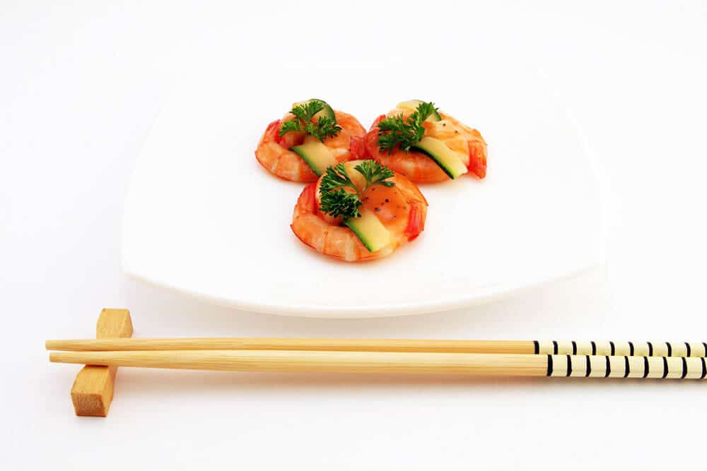 Best souvenirs from Japan - Decorated chopsticks next to a dish of marinated shrimps
