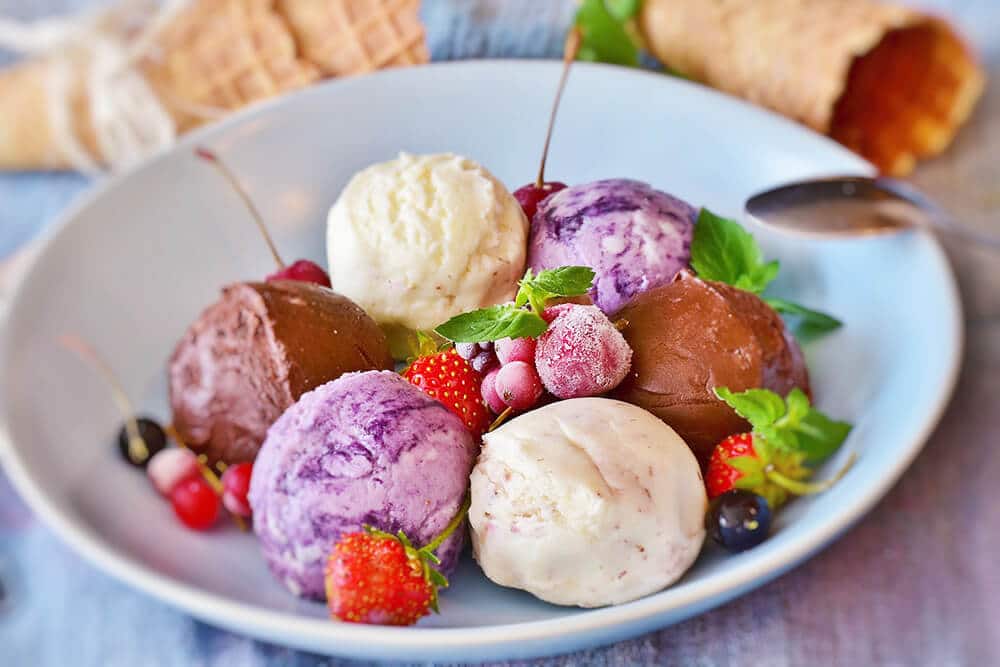 Italian gelato and frozen fruit on a porcelain plate