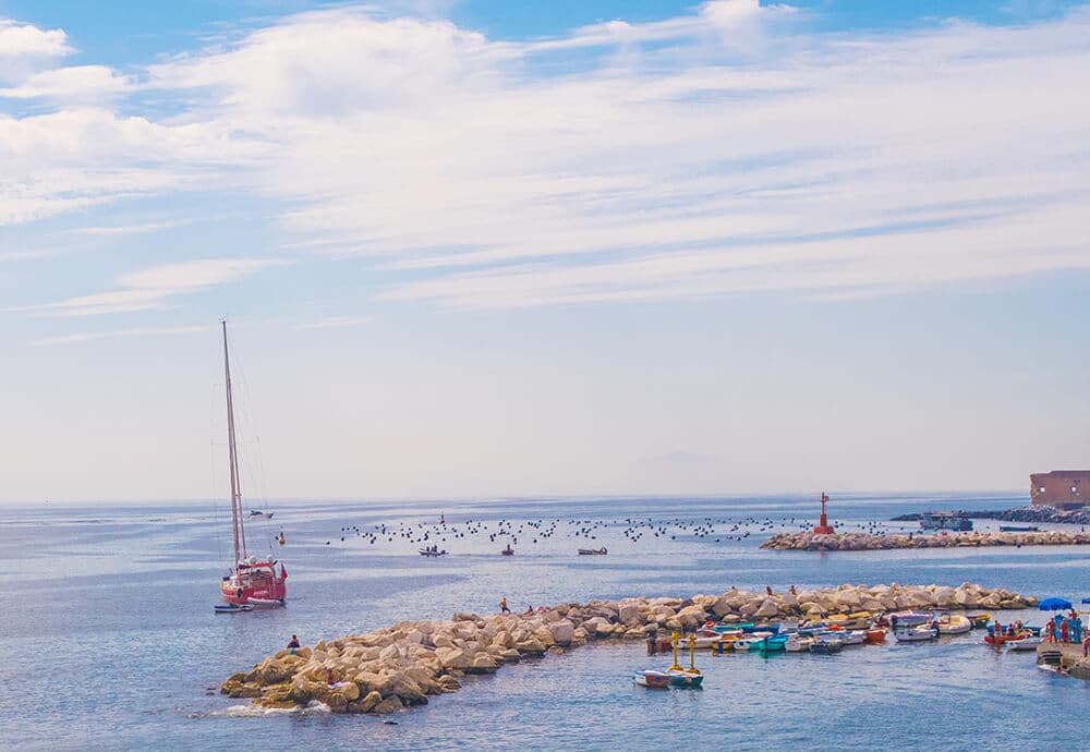 A beautiful view of fishermen boats from Santa Lucia in Naples, one of the best areas to stay in Naples