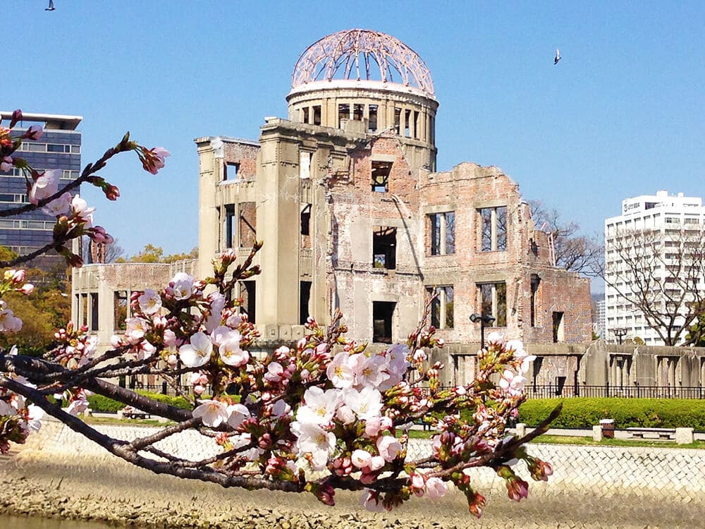 The Atomic Bomb Dome in Hiroshima surrounded by cherry trees