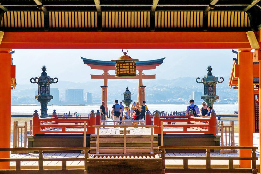 Things to do in Miyajima | Lantern and Miyajima torii seen from the inside of Itsukushima shrine