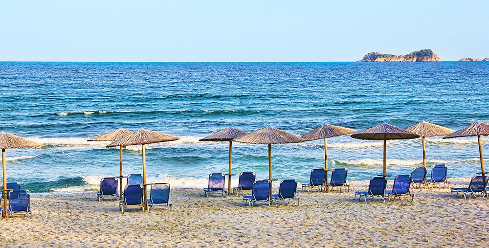 Beaches on the Amalfi Coast | Beach umbrellas and blue chairs at Caico beach on the Amalfi Coast