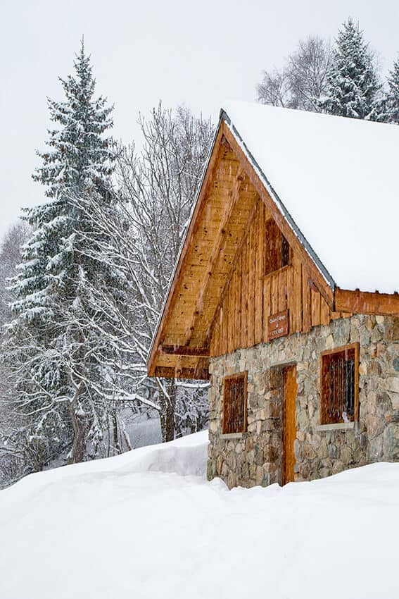 Mountain chalet covered in snow in the Italian Dolomites in winter