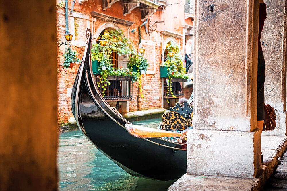 A gondola in one of the narrow canals in Venice (Italy)