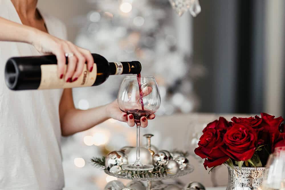 Woman pouring Italian red wine in a goblet