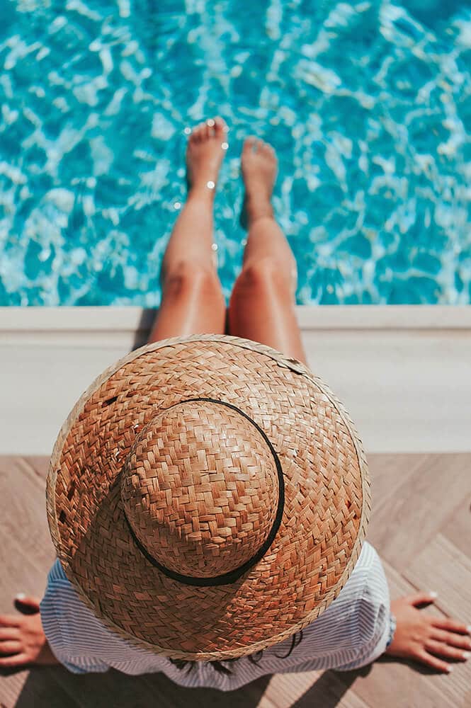 Amalfi Coast hotels - woman enjoying her trip to Positano with her feet inside an infinity pool