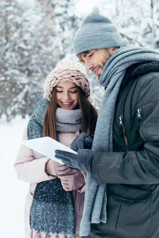 Couple exploring in the winter snow