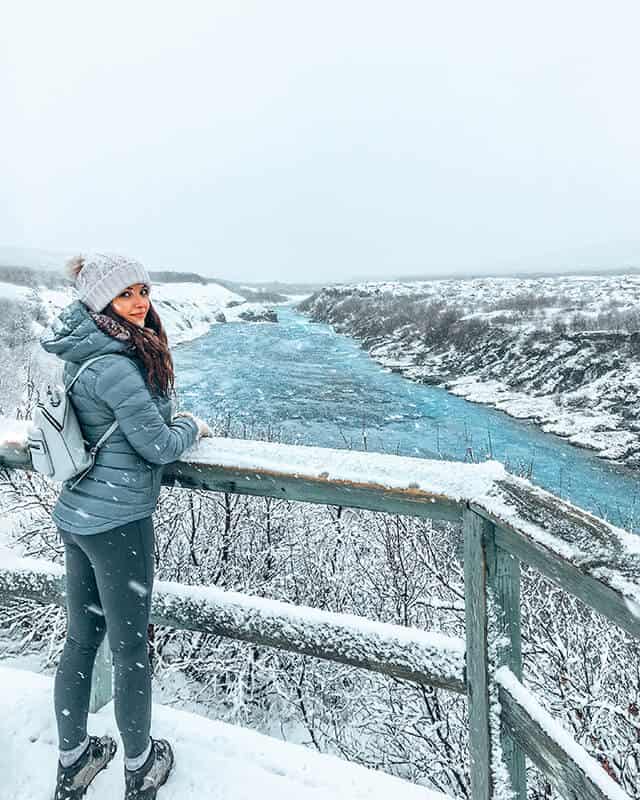 Girl overlooking a river in winter