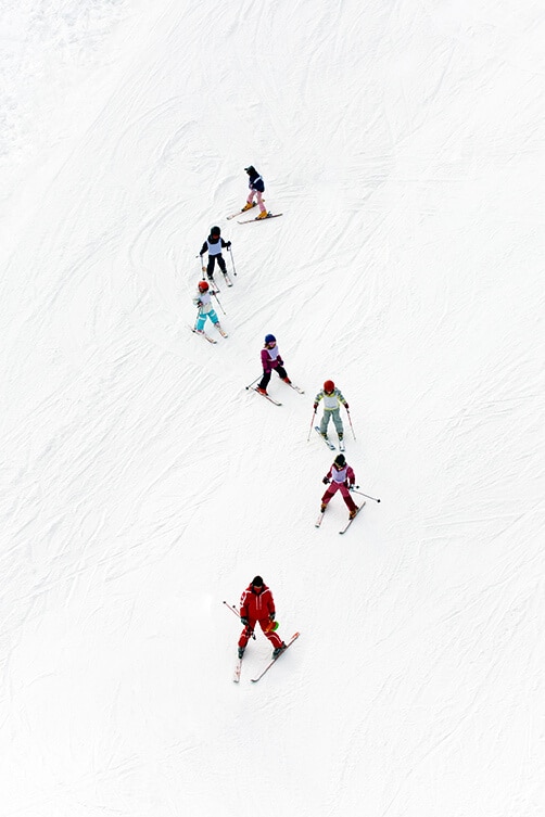 Kids and adults skiing on the Italian Dolomites