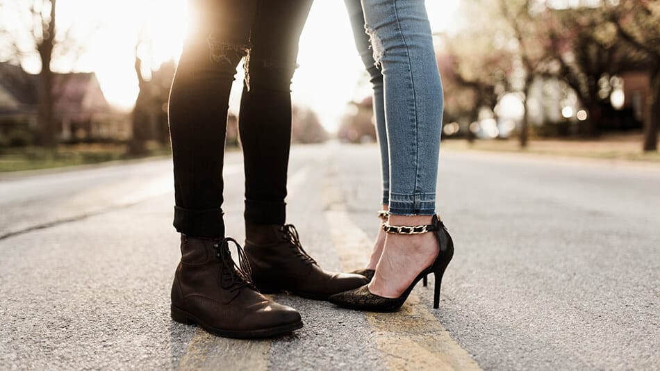 Shoes are cruise essentials: man and woman standing next to each other wearing elegant boots and stilettos