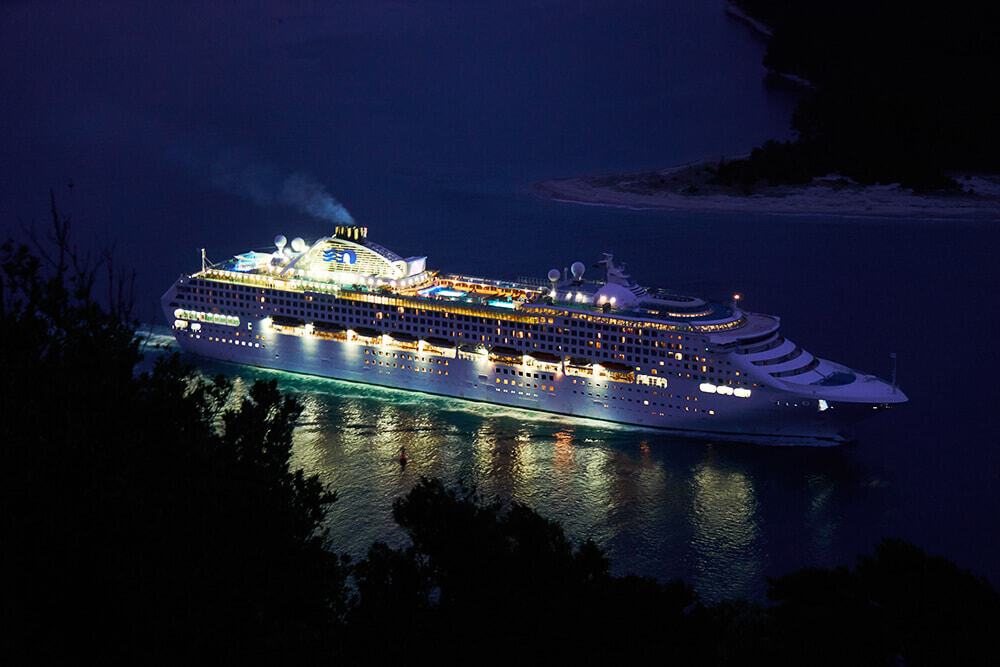 Things to do in Waikiki at night | A cruise ship sailing off the Waikiki Coast at night