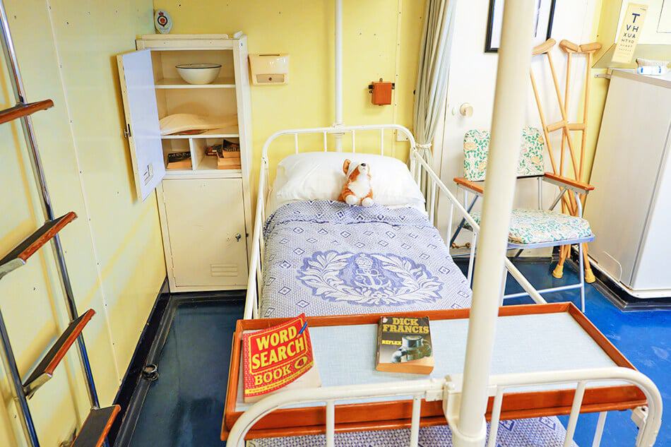 4 days in Scotland - Cuddly Corgi laying in an infirmary bed on the Royal Yacht Britannia during the Cuddly Corgi Treasure Hunt