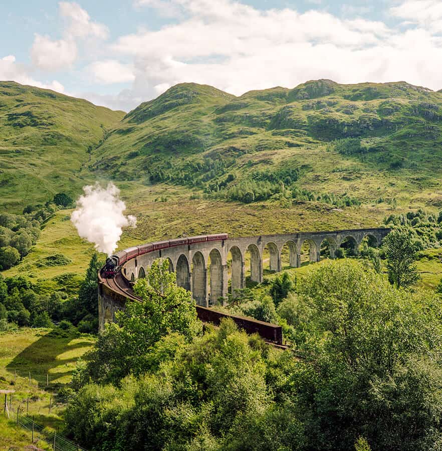 The Harry Potter train in Scotland on the iconic stone bridge