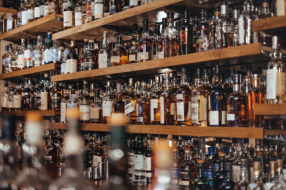 Shelves full of whiskey bottles on a distillery tour in Scotland