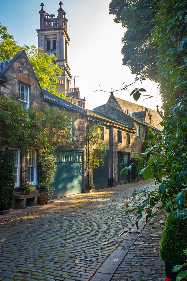 Vicolo pieno di vegetazione e casette antiche lungo l'itinerario per il tour di Harry Potter a Edimburgo