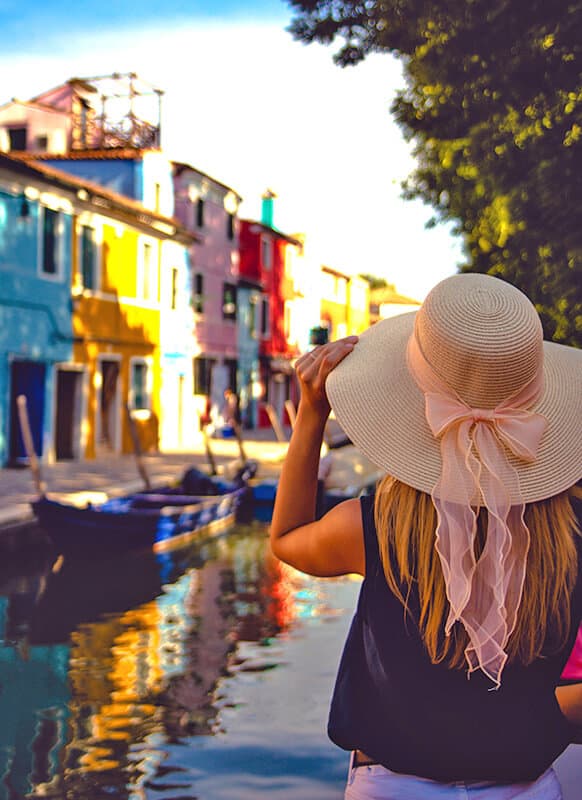 Woman in a stylish hat in Burano (Italy)