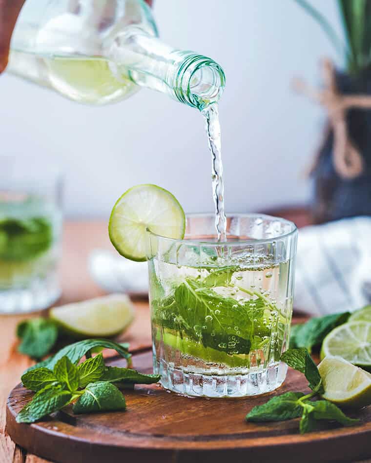 Barman preparing a mojito with fresh Keys lime and mint leaves in Key West