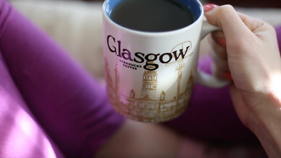 Girl drinking off a Glasgow mug from the Starbucks Scotland collection