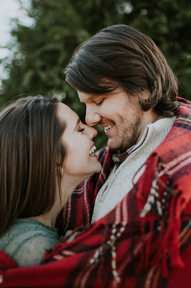 Couple in love wrapped in a tartan blanket