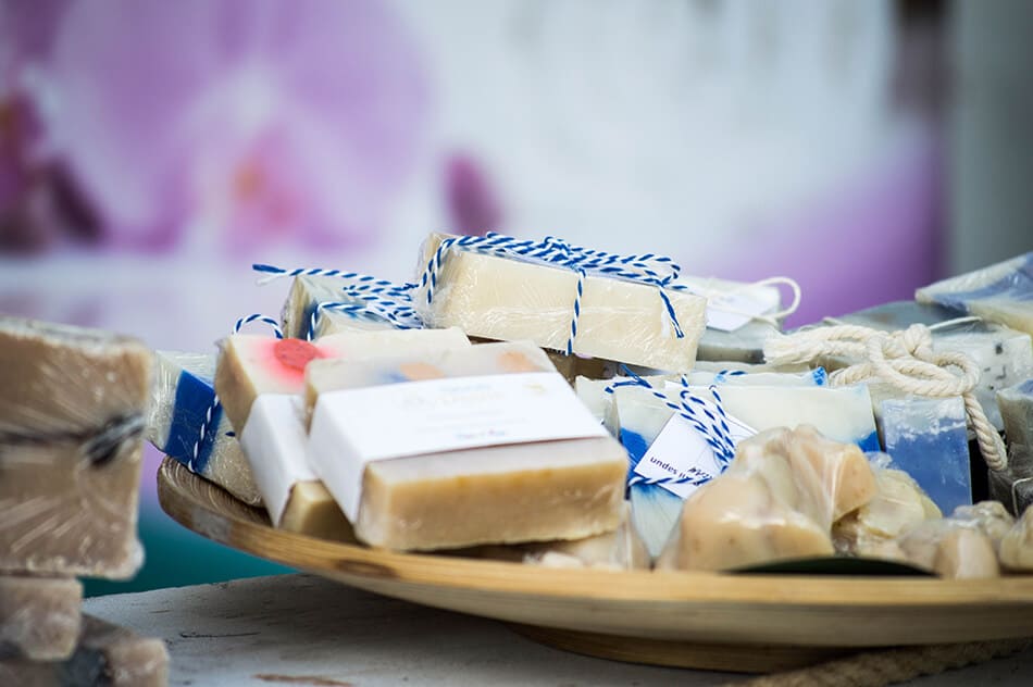 Bars of handmade natural soap wrapped in blue and white ribbon