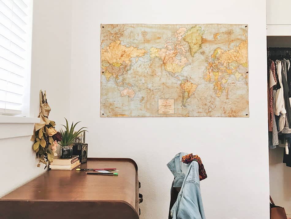 Vintage world map hanging on a wall