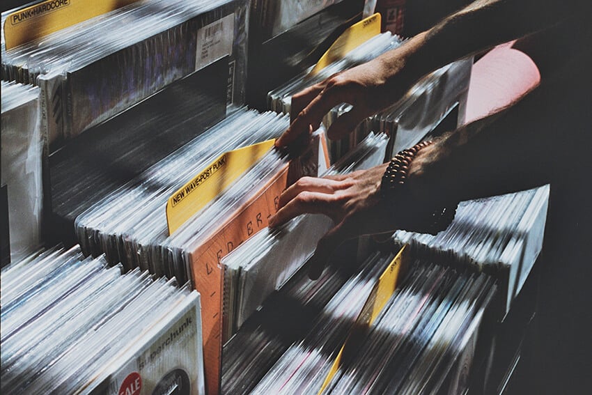 Una persona cerca tra i dischi di vinile in esposizione a un mercato di Londra
