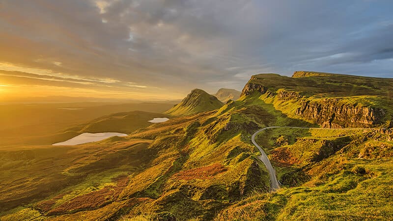 Planning a trip to Scotland: view of a green valley at sunset in the Highlands