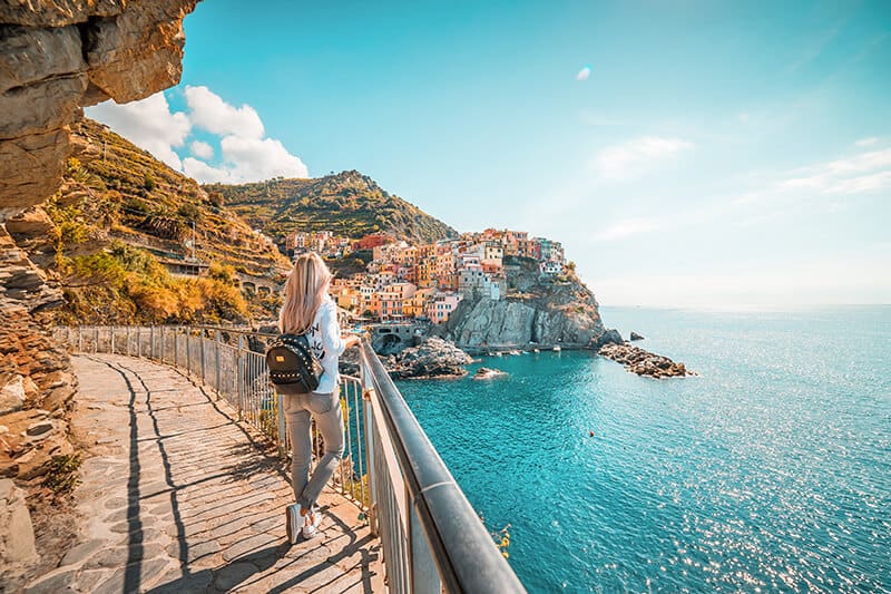 Girl at Cinque Terre watching over one of the coastal towns