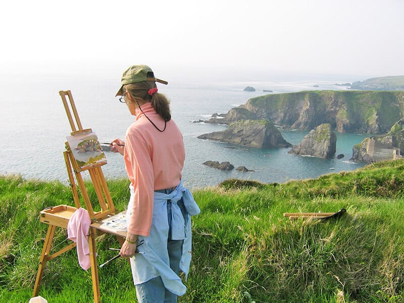 Local artist painting the Cliffs of Moher in Ireland