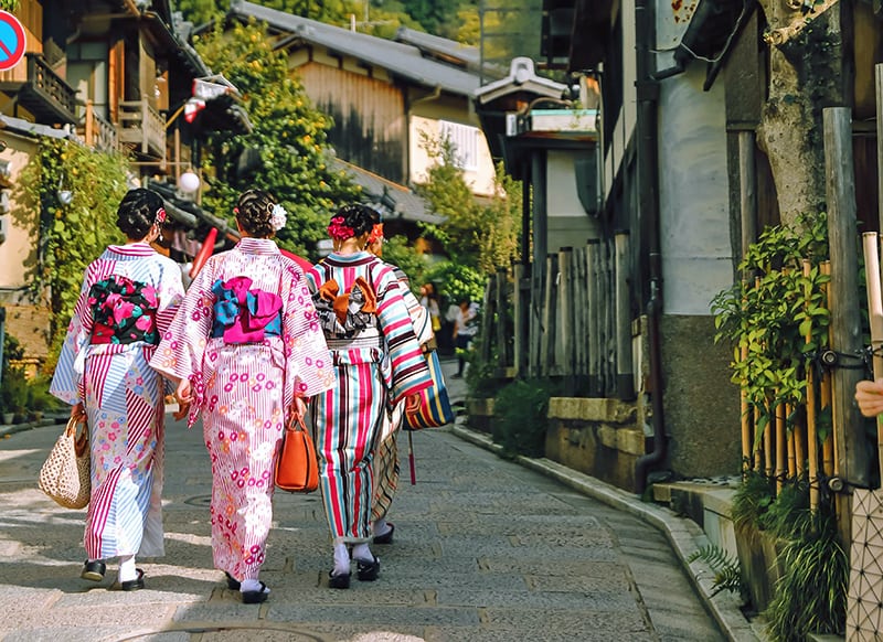 Maiko girls walking through the streets of Kyoto on a day trip from Tokyo
