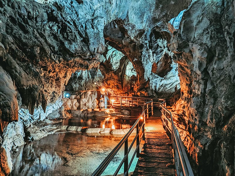 Wooden bridge inside Dunmore Caves in Ireland hidden under the rocks