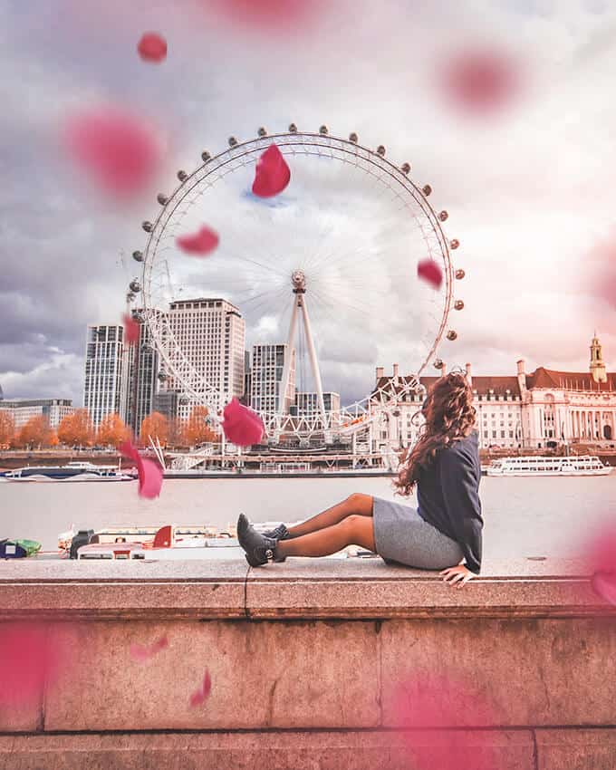 Petals of cherry blossoms flying in the air near the Coca Cola London Eye