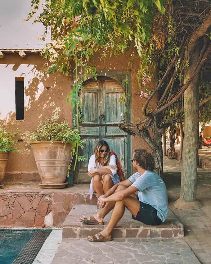 Couple sitting on the steps of a Tuscany villa in Italy