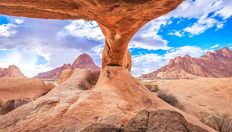 Hiking under a massive arch at Arches National Park (Utah)